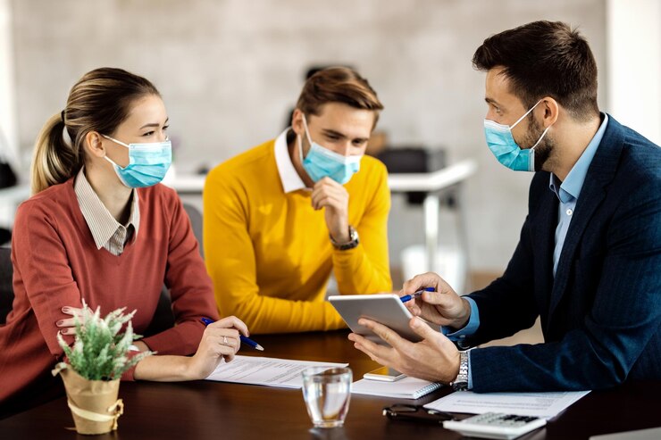 insurance agent couple using touchpad while wearing face masks meeting 637285 10906
