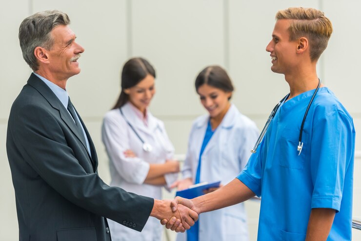 senior male businessman shakes hands doctors hospital 85574 10694