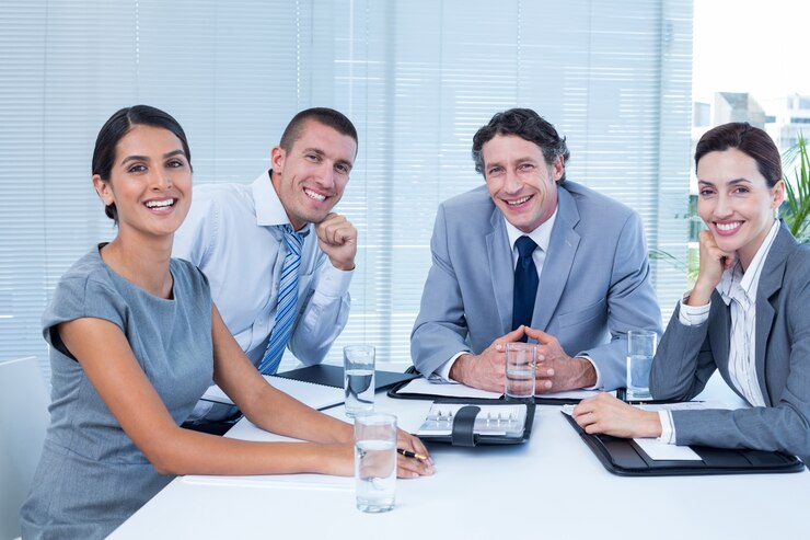 smiling business team sitting desk 13339 137256